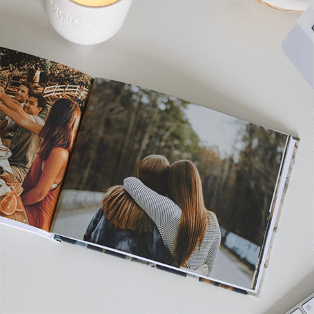 A photobook with two friends hugging