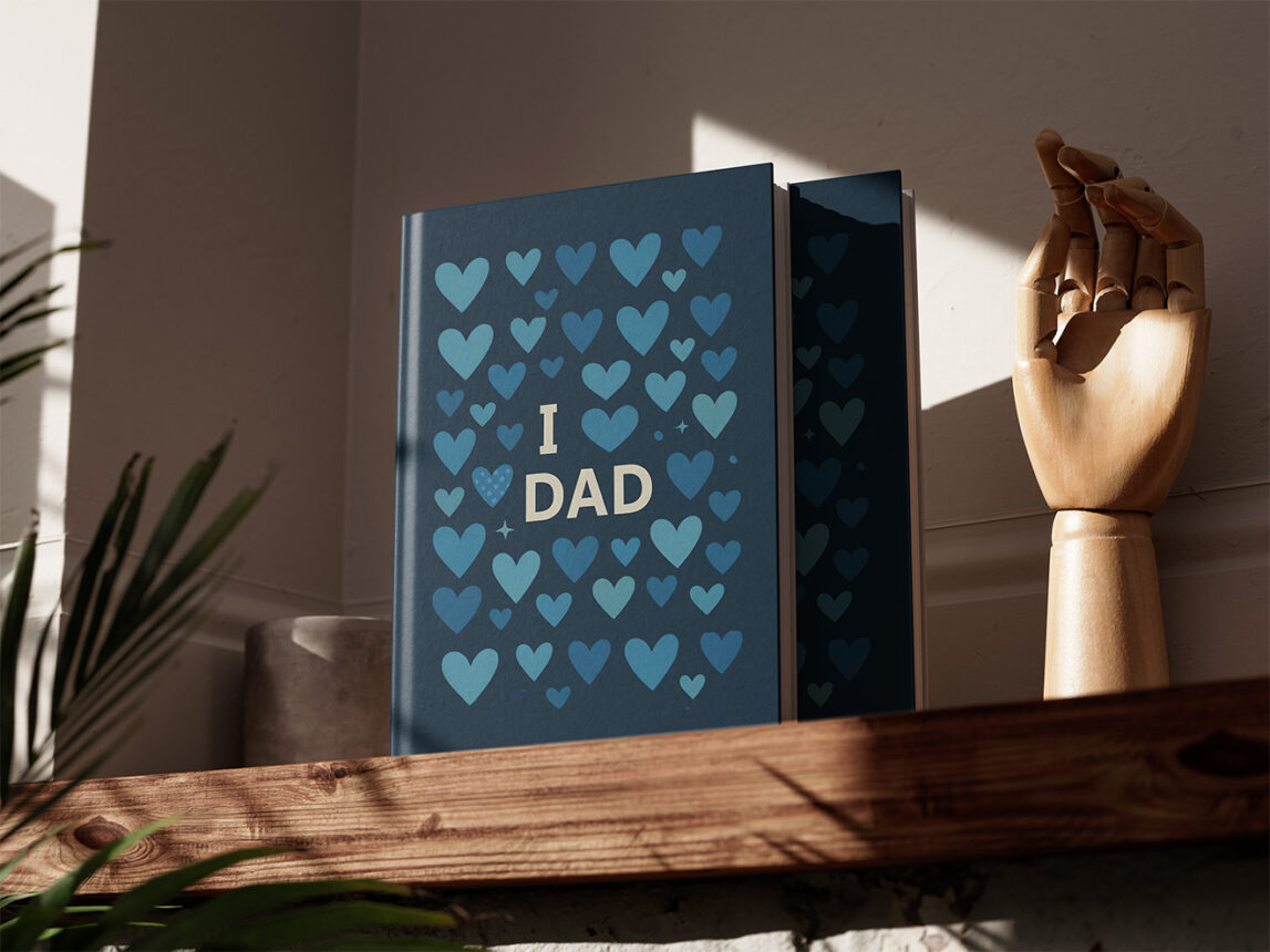 Personalised I Love Dad photo album with blue heart cover on wooden shelf in natural light