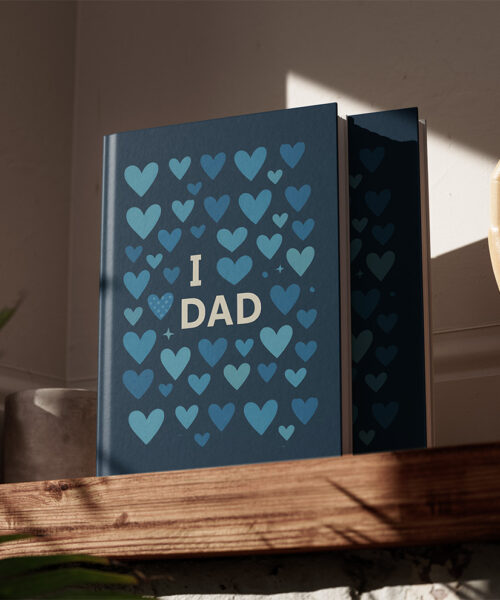 Personalised I Love Dad photo album with blue heart cover on wooden shelf in natural light